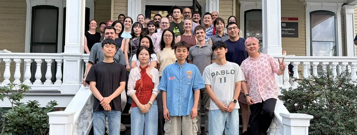 Linguistics department group photo in front of Linguistics building